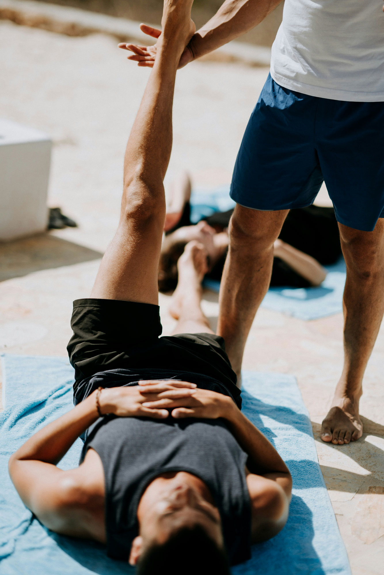Fitness Coach Helping Client Lift Leg for Exercise