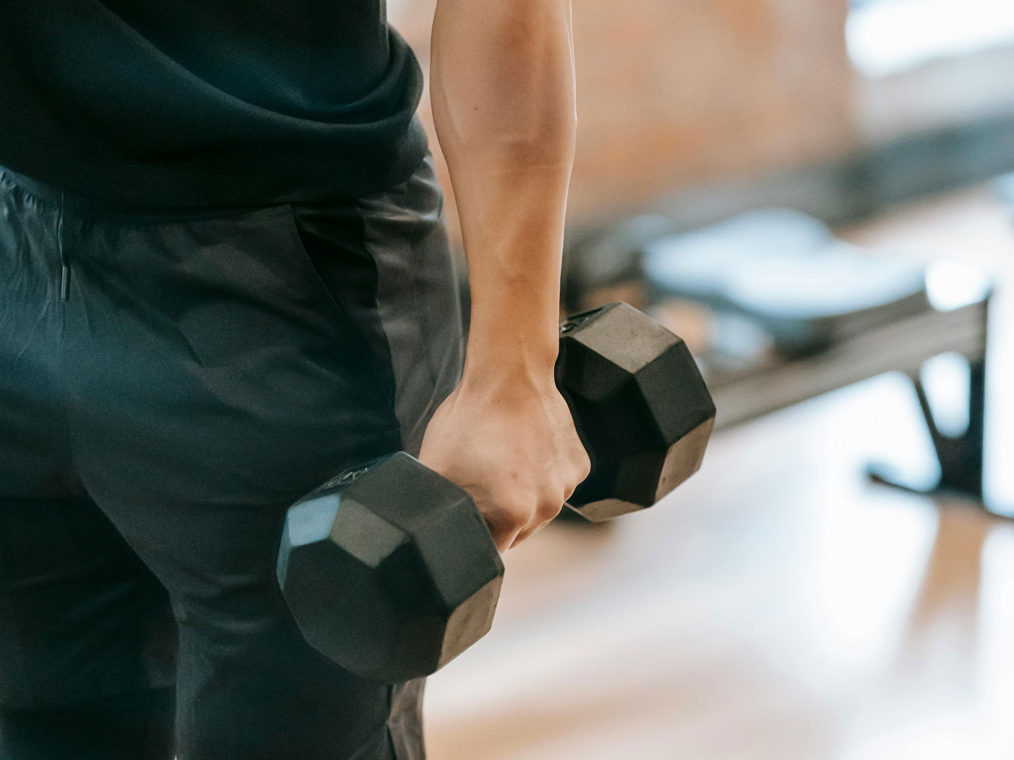 Man Holding Weights in a Gym