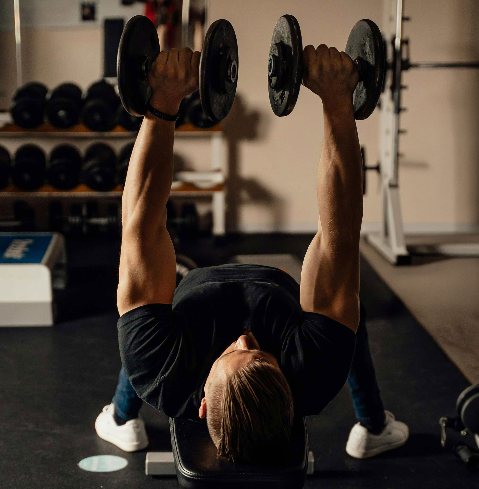 Young Man Lifting Weights in Home Gym